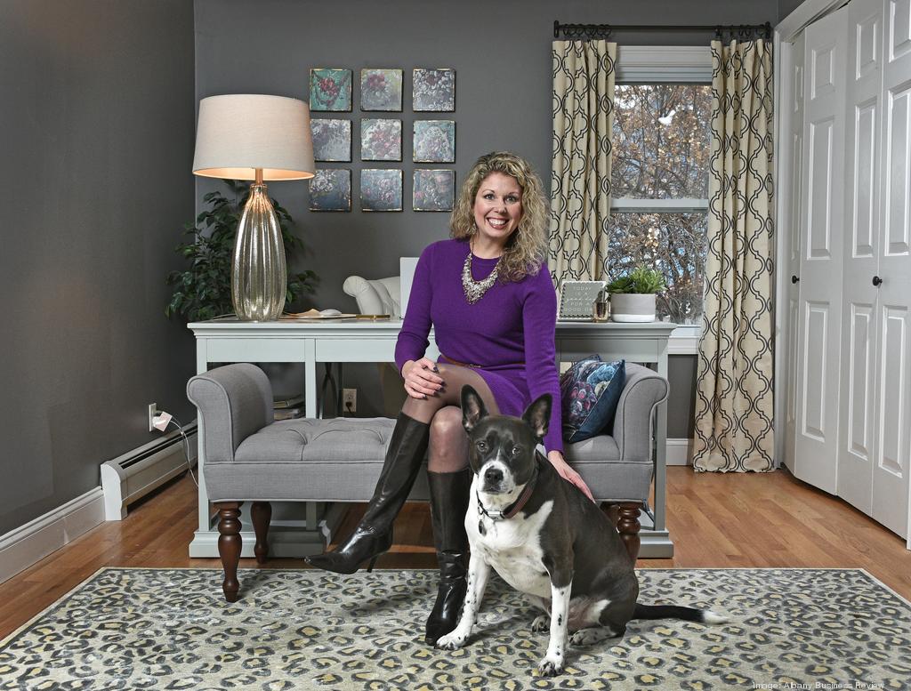 Gretchen Meyer in her home office with her dog, Jackson.